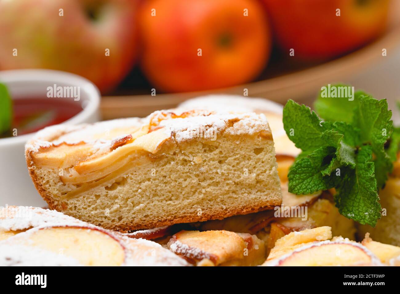 Frsh baked apple pie and cup of herbal tea with mint leaves close up on white background Stock Photo