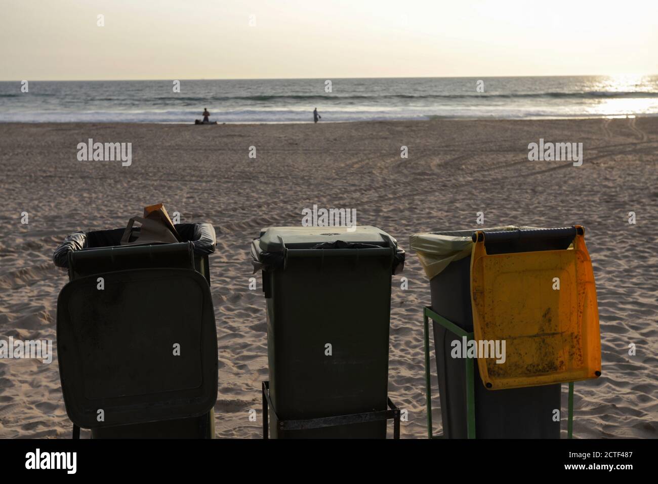 Isolated trash bins on the beach facing the Atlantic Ocean in Costa da Caparica in Lisbon. Environment concept lifestyle of waste management and recyc Stock Photo