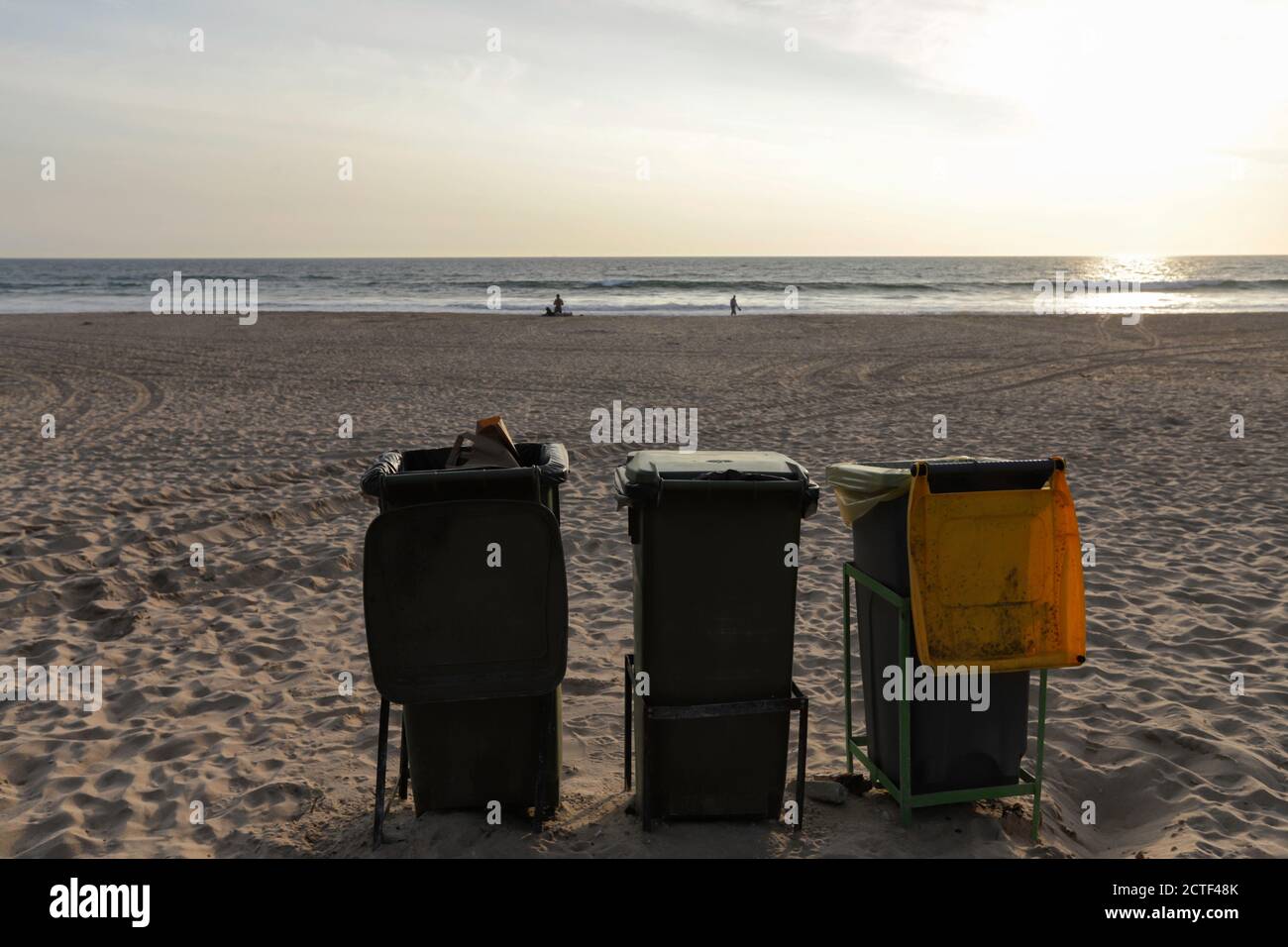 Isolated trash bins on the beach facing the Atlantic Ocean in Costa da Caparica in Lisbon. Environment concept lifestyle of waste management and recyc Stock Photo