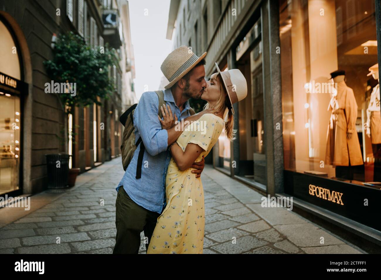 Couple of young tourist in love having a romantic kiss in the city. Boyfriend and girlfriend having a special romantic moment on the street. Love, tou Stock Photo