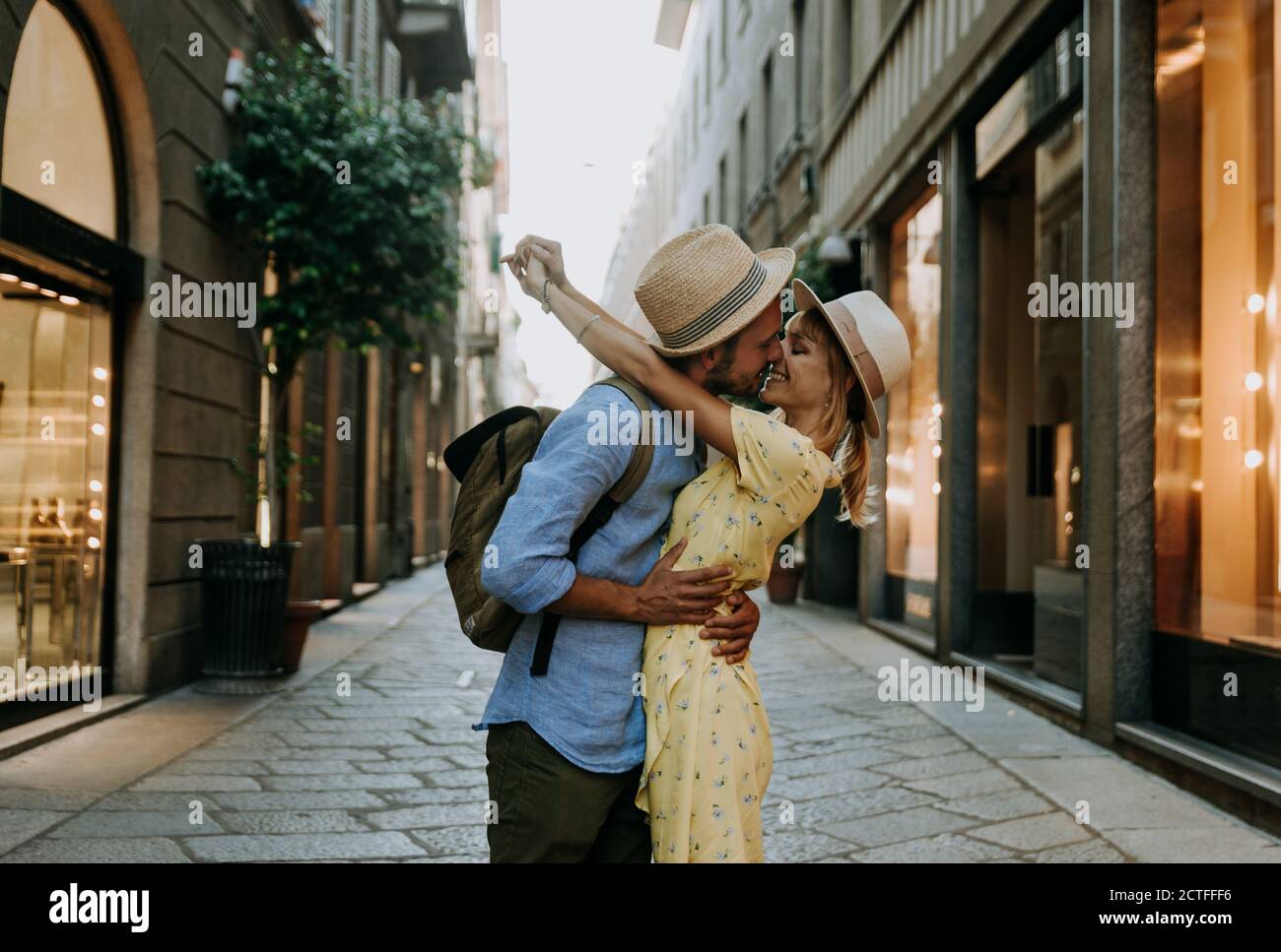 Couple of young tourist in love having a romantic kiss in the city. Boyfriend and girlfriend having a special romantic moment on the street. Love, tou Stock Photo