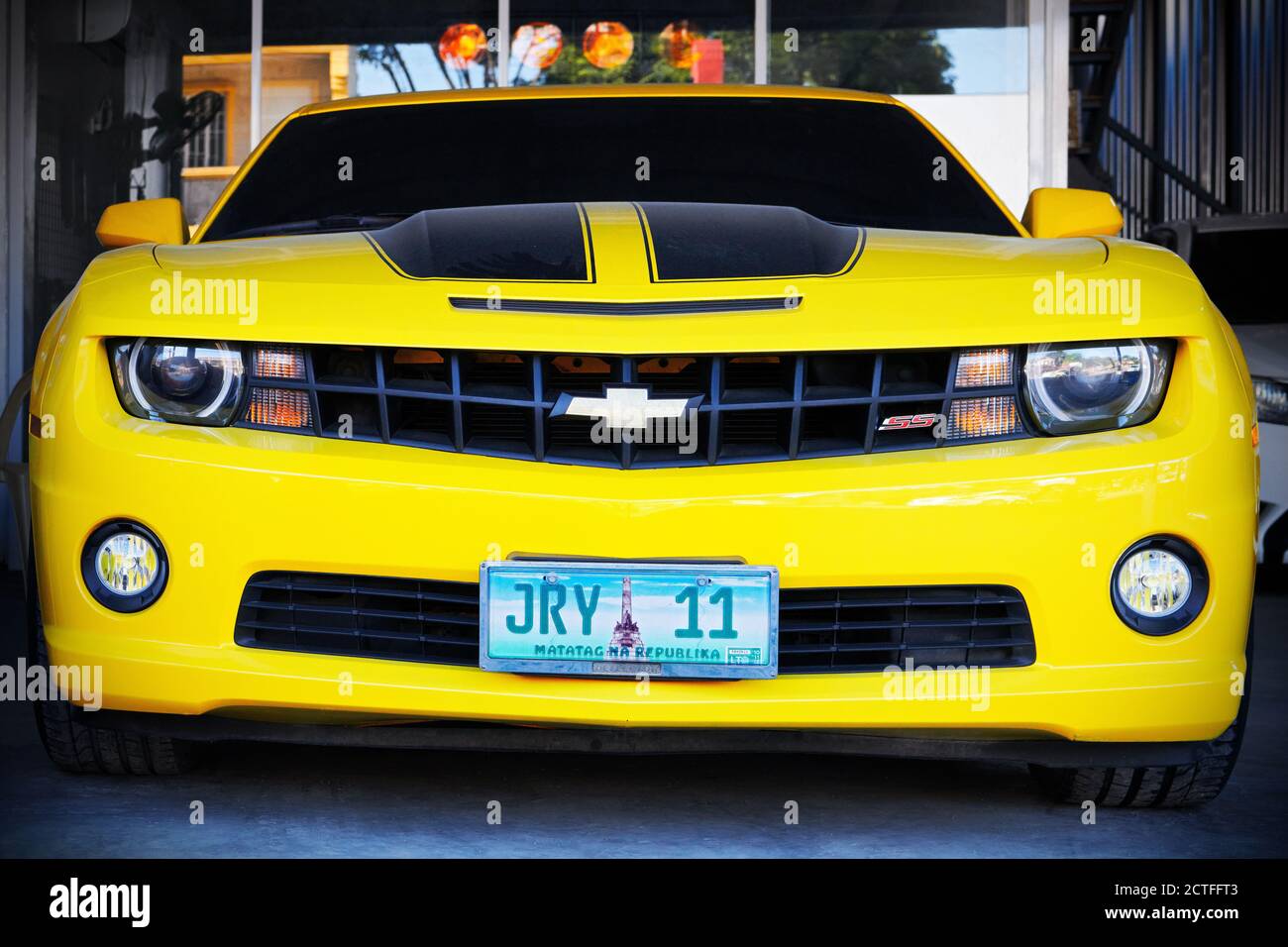 Isolated front view of a new powerful looking black and yellow Chevrolet Camaro sports car parking along the road in Iloilo city, Philippines, Asia Stock Photo