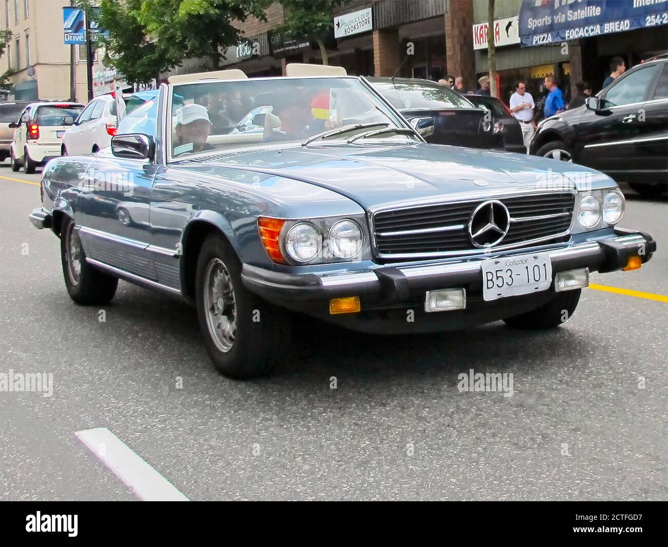 Blue colored Mercedes-Benz convertible Coupe sports car with detachable roof seen in traffic in downtown Vancouver city, Canada, Northern America Stock Photo