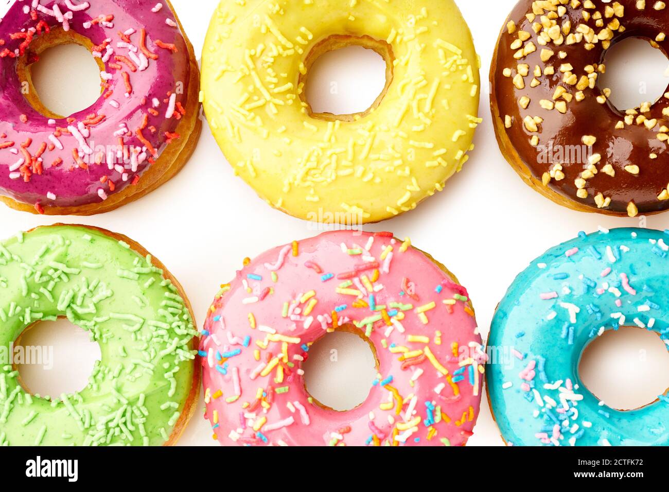 Various glazed sweet donuts top view flat lay on white background close ...