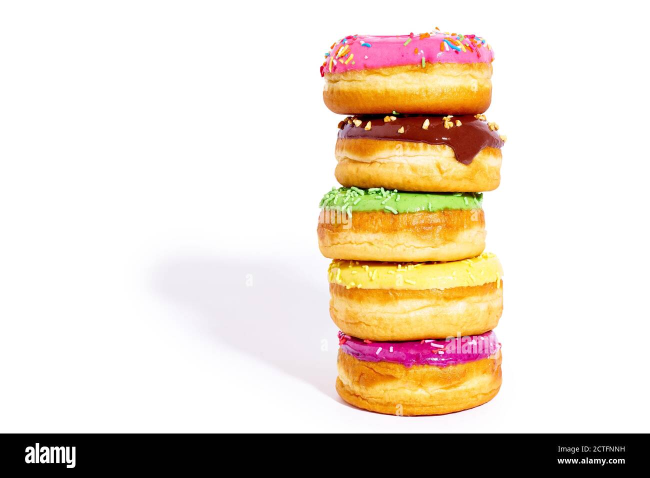 A pile of glazed donuts isolated on white background with copy space ...