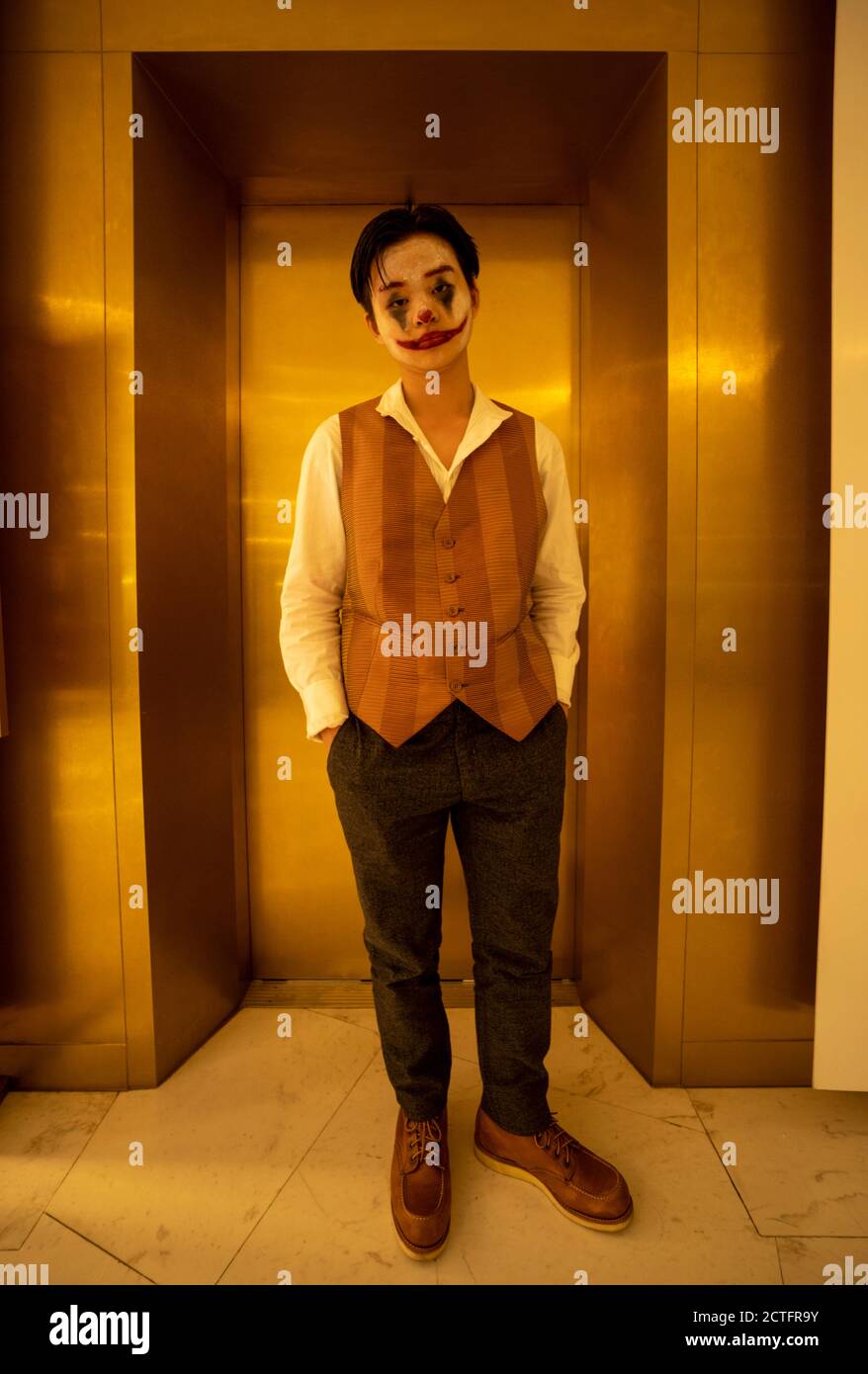 Boy dressed as Joker Stock Photo