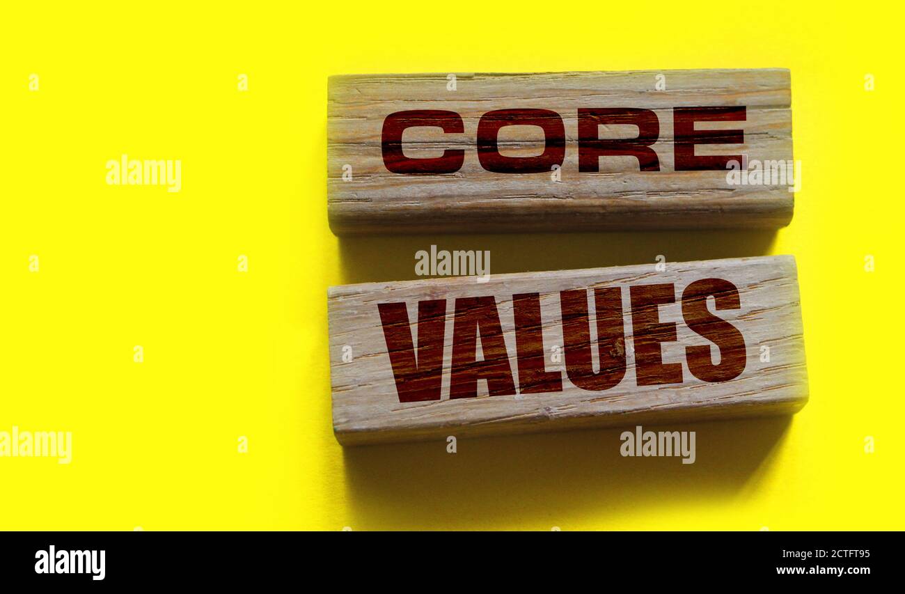 core values words on wooden blocks on yellow background. Business ethics concept Stock Photo
