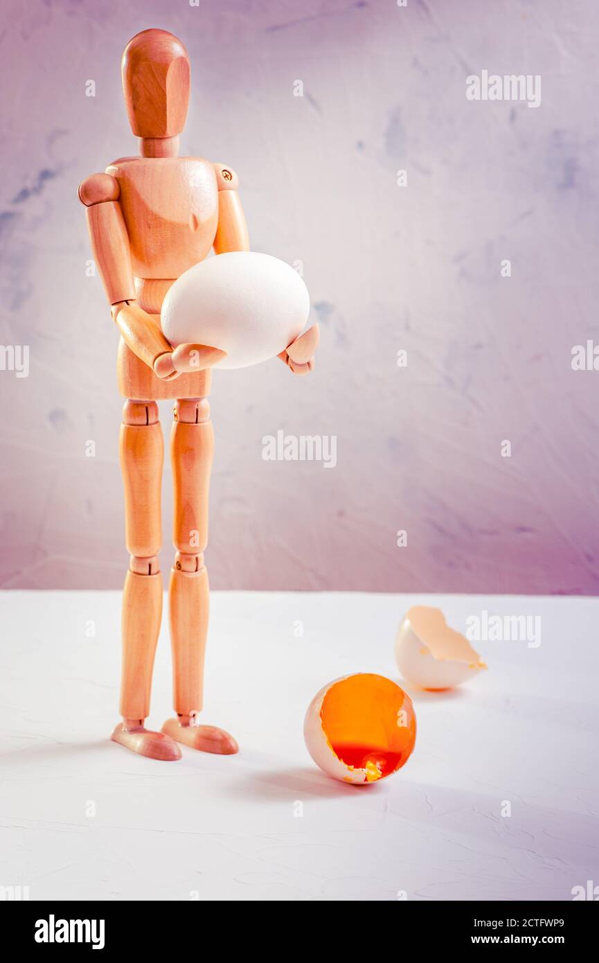 Vertical shot of a gestalt figurine holding an egg Stock Photo