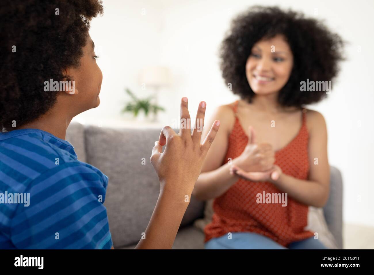 Mother and son communicating with each other in sign language Stock Photo