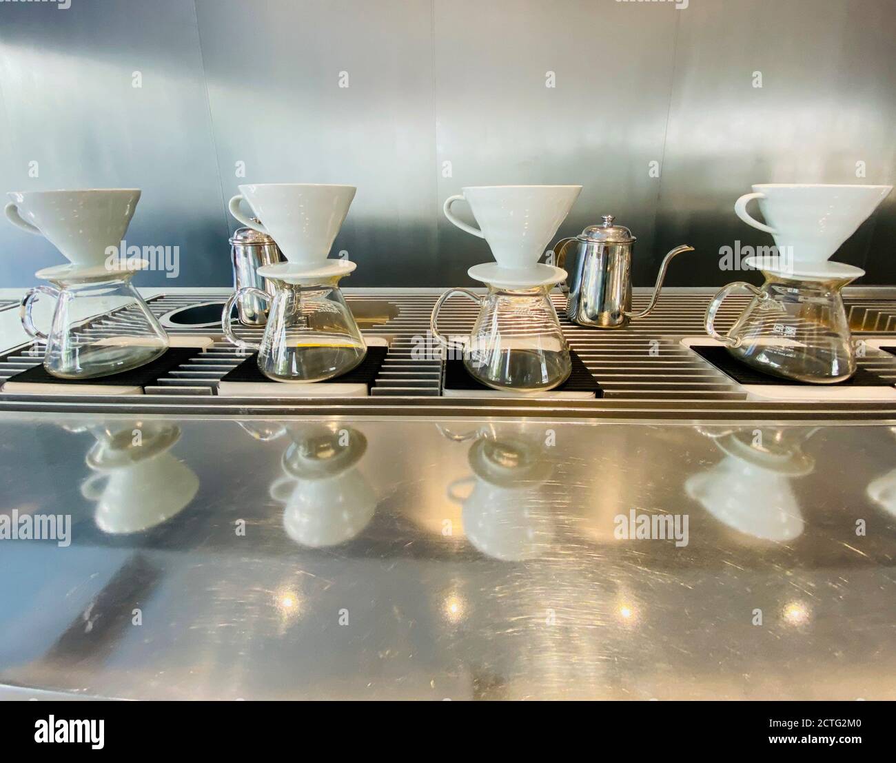 Coffee percolators on steel counter Stock Photo Alamy