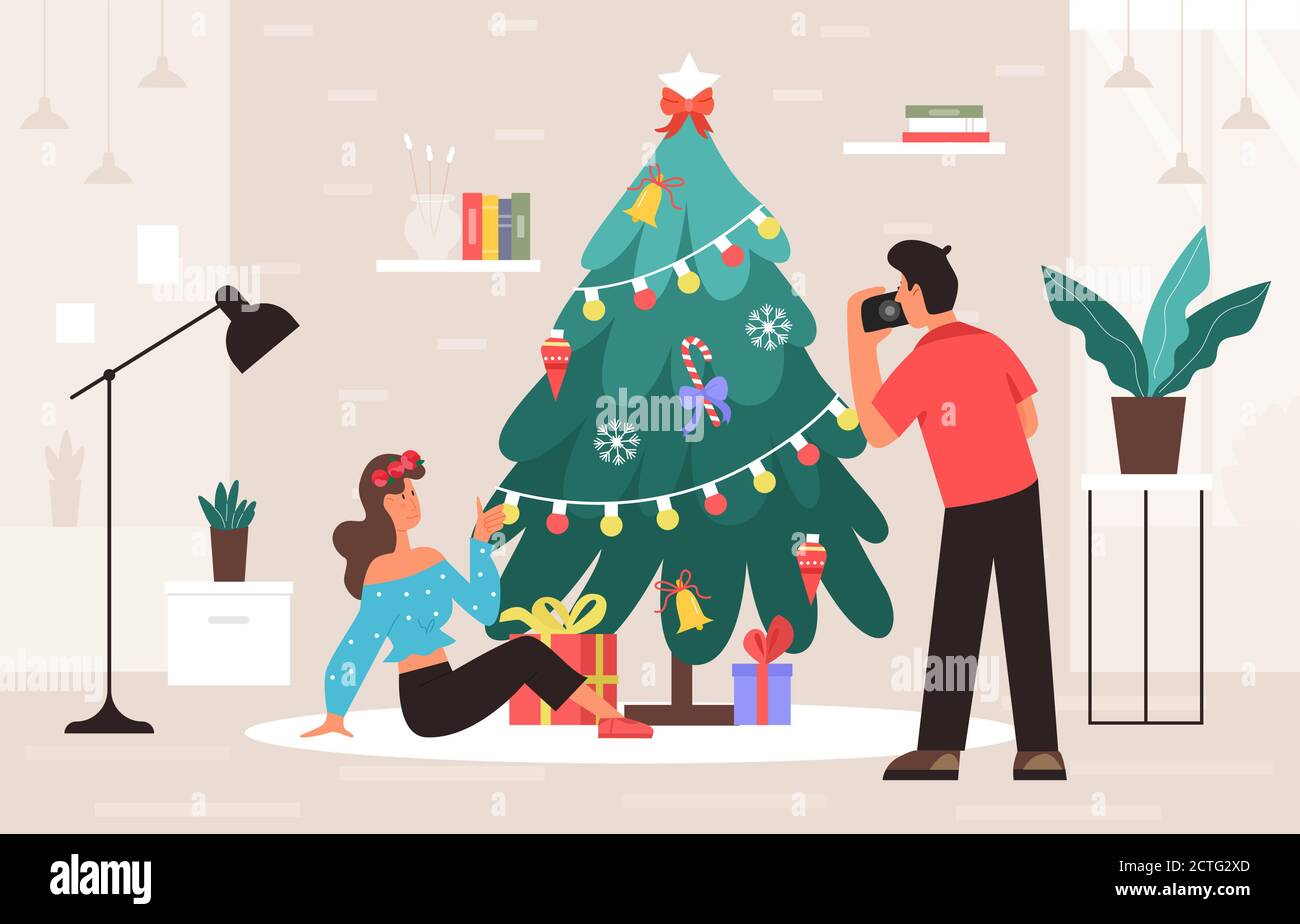 Christmas photo session vector illustration. Cartoon flat photographer character standing with camera, photographing beautiful girl sitting next to Christmas tree in home or studio interior background Stock Vector