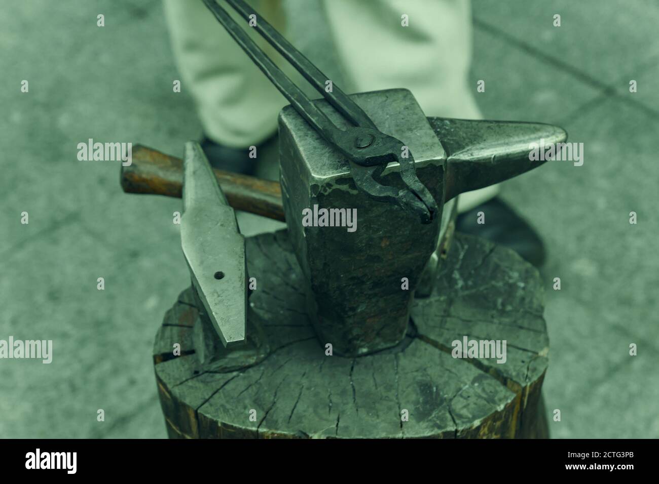 Working metal tools in blacksmith's workshop, close-up, selective focus, toned Stock Photo