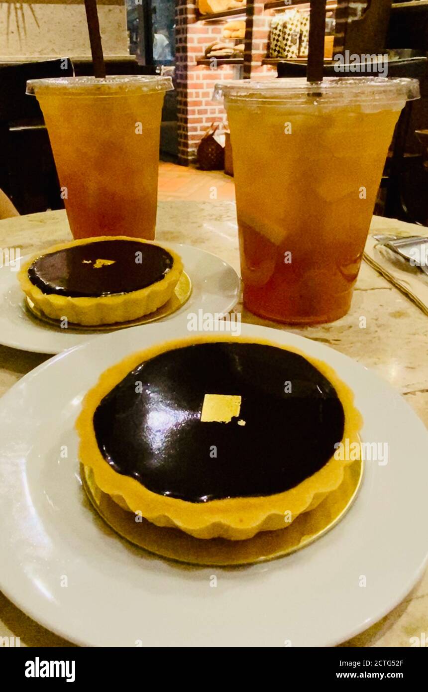 Chocolate tarts and drinks on café table Stock Photo