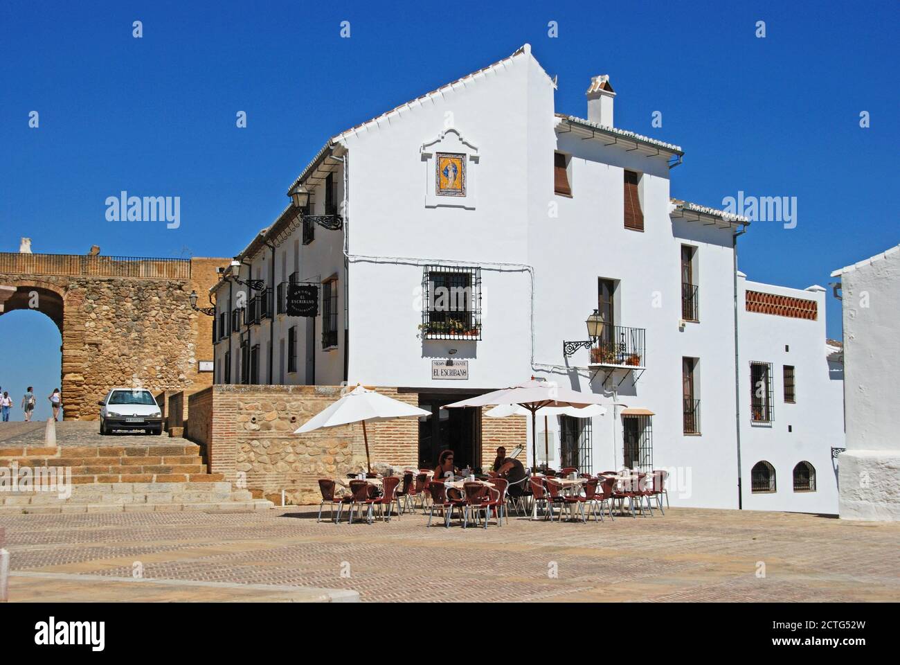 Statue of Pedro Espinosa in the Plaza de Santa Maria with a pavement cafe  and the giants arch to the rear, Antequera, Spain Stock Photo - Alamy