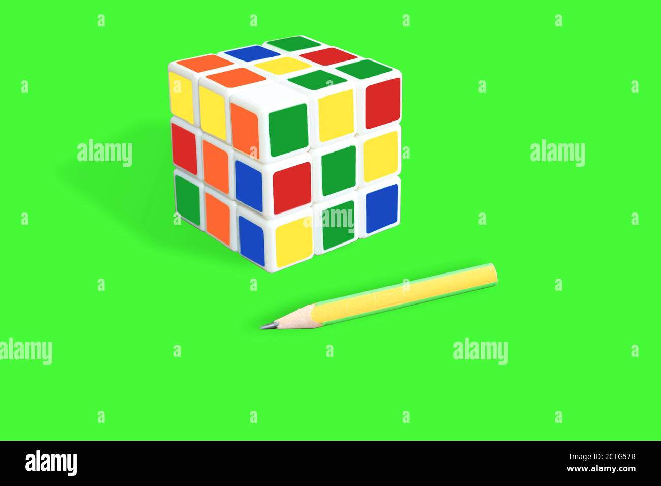 Rubik's cube isolated on green background Stock Photo