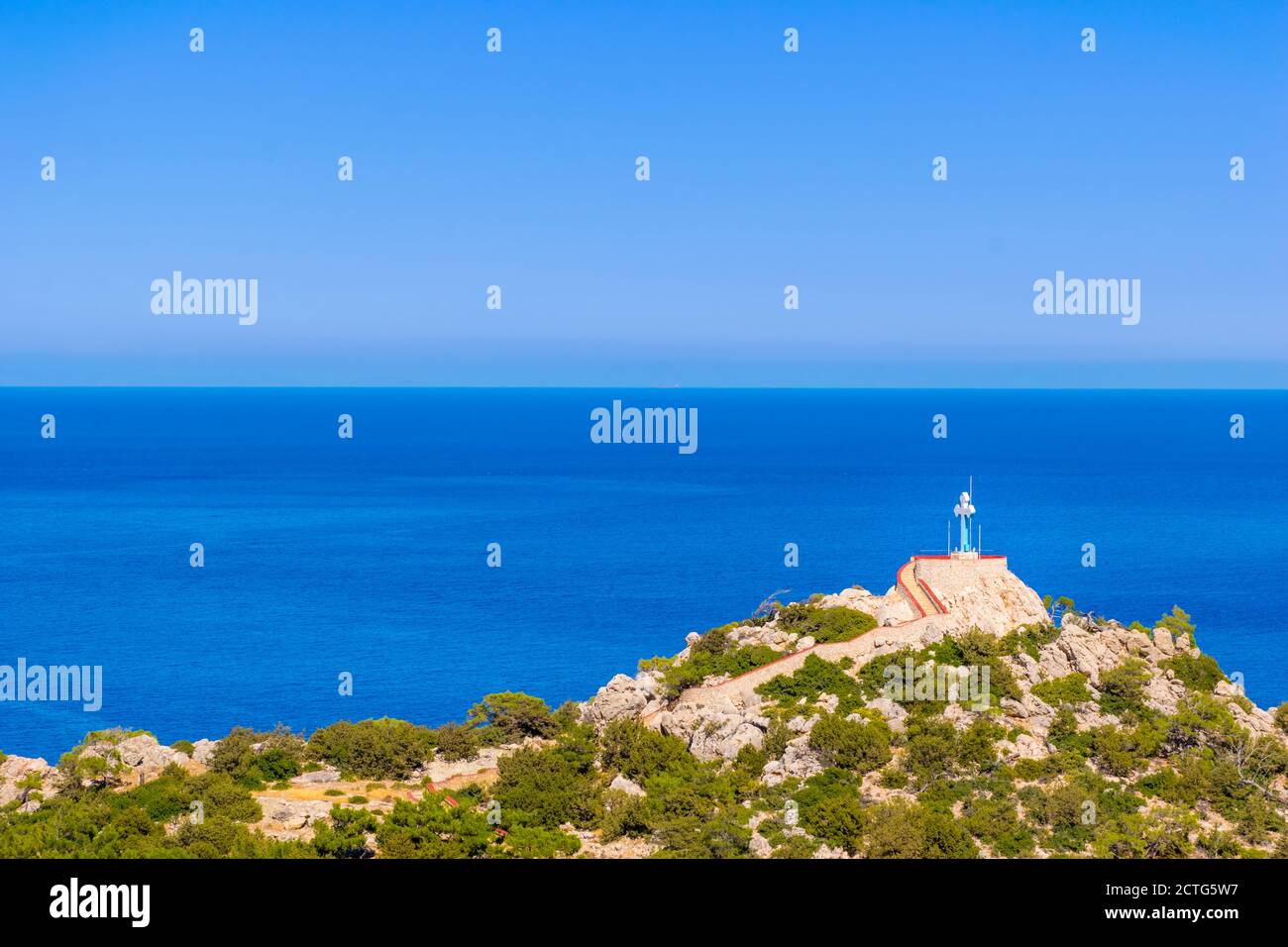 Panoramic view of Large Religious Cross on top of a hill with Aegean Sea in the background, Karpathos Island, Greece Stock Photo