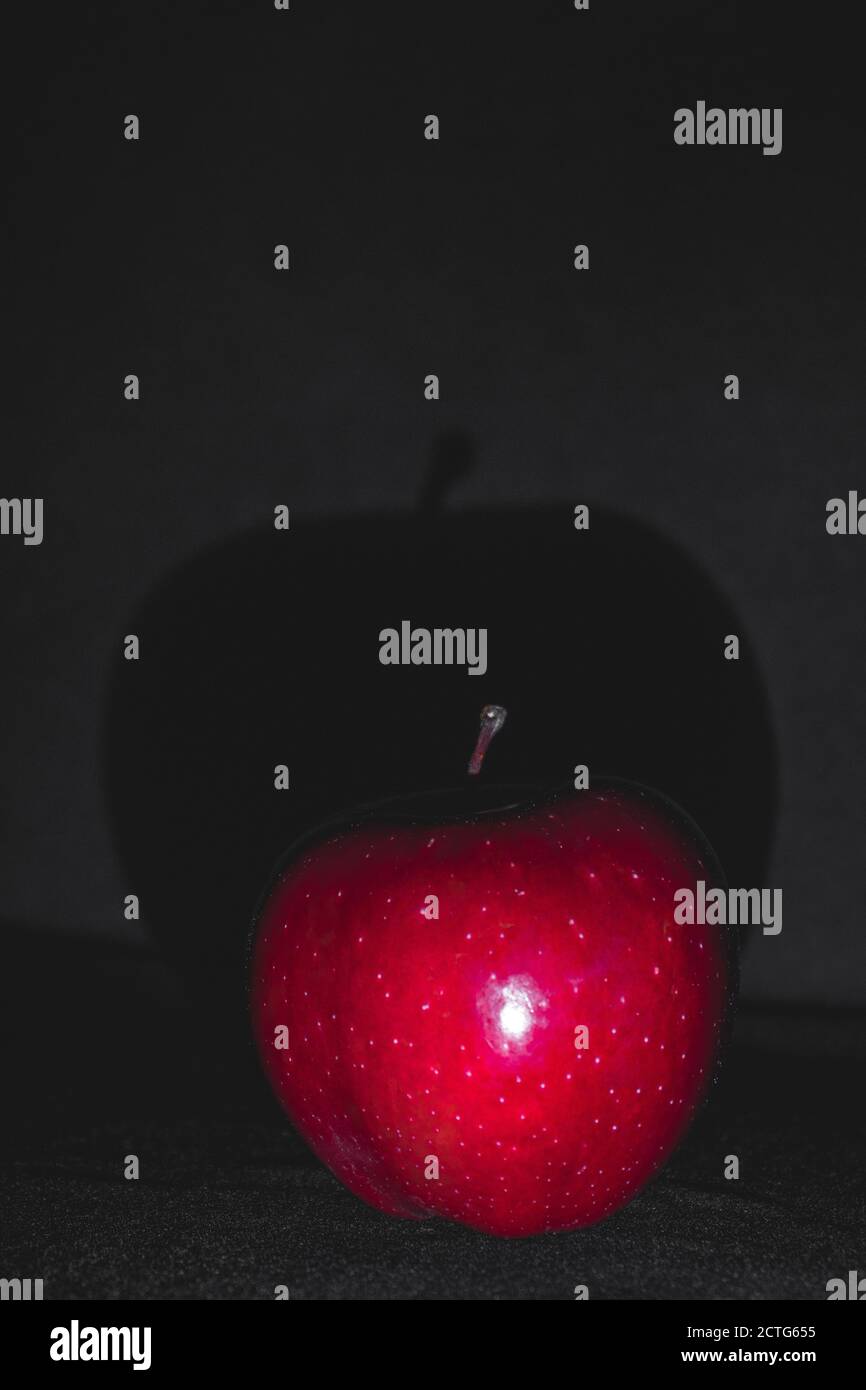 Apple fruit, abstract shadow, black background, red apple Stock Photo