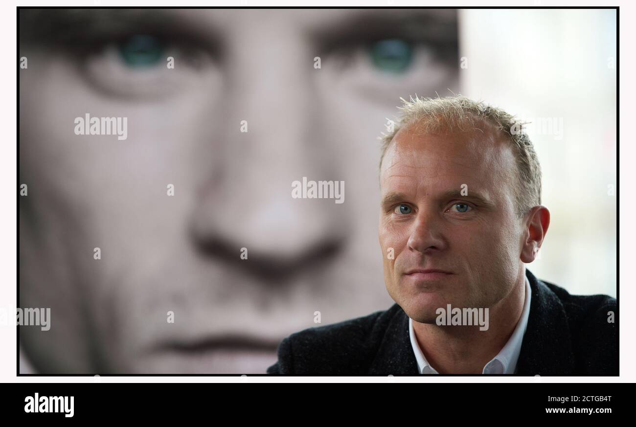 DENNIS BERGKAMP IN AMSTERDAM AT THE LAUNCH OF HIS BIOGRAPHY, IN FRONT OF A PICTURE OF THE COVER OF HIS BOOK. PICTURE: © MARK PAIN / ALAMY Stock Photo