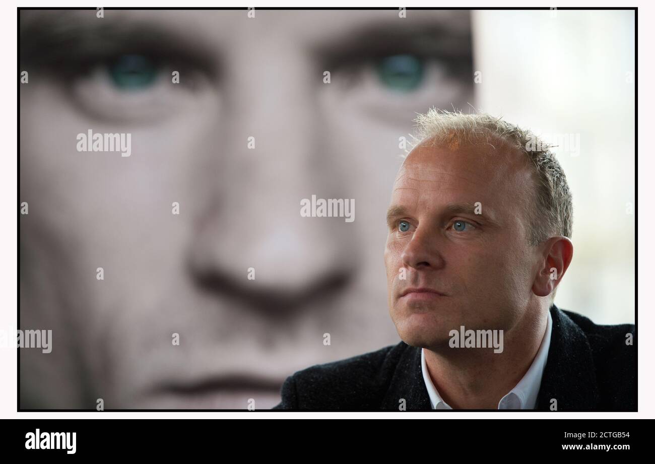 DENNIS BERGKAMP IN AMSTERDAM AT THE LAUNCH OF HIS BIOGRAPHY, IN FRONT OF A PICTURE OF THE COVER OF HIS BOOK. PICTURE: © MARK PAIN / ALAMY Stock Photo
