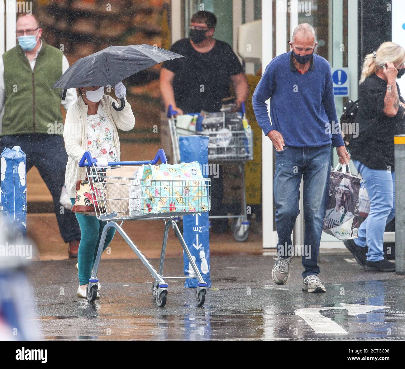 New Forest, Hampshire. 23rd September 2020. UK Weather. Shoppers at Tesco in the New Forest are caught out by heavy rain showers. Credit Stuart Martin/Alamy Live News Stock Photo