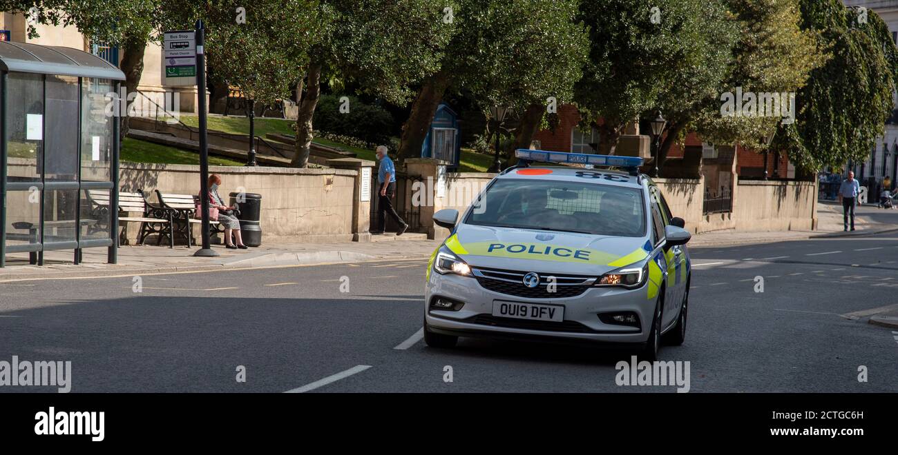 Windsor, Berkshire, England, UK. 2020. Police patrol car on a shout passing the parish church on the High Street in Windsor. Stock Photo