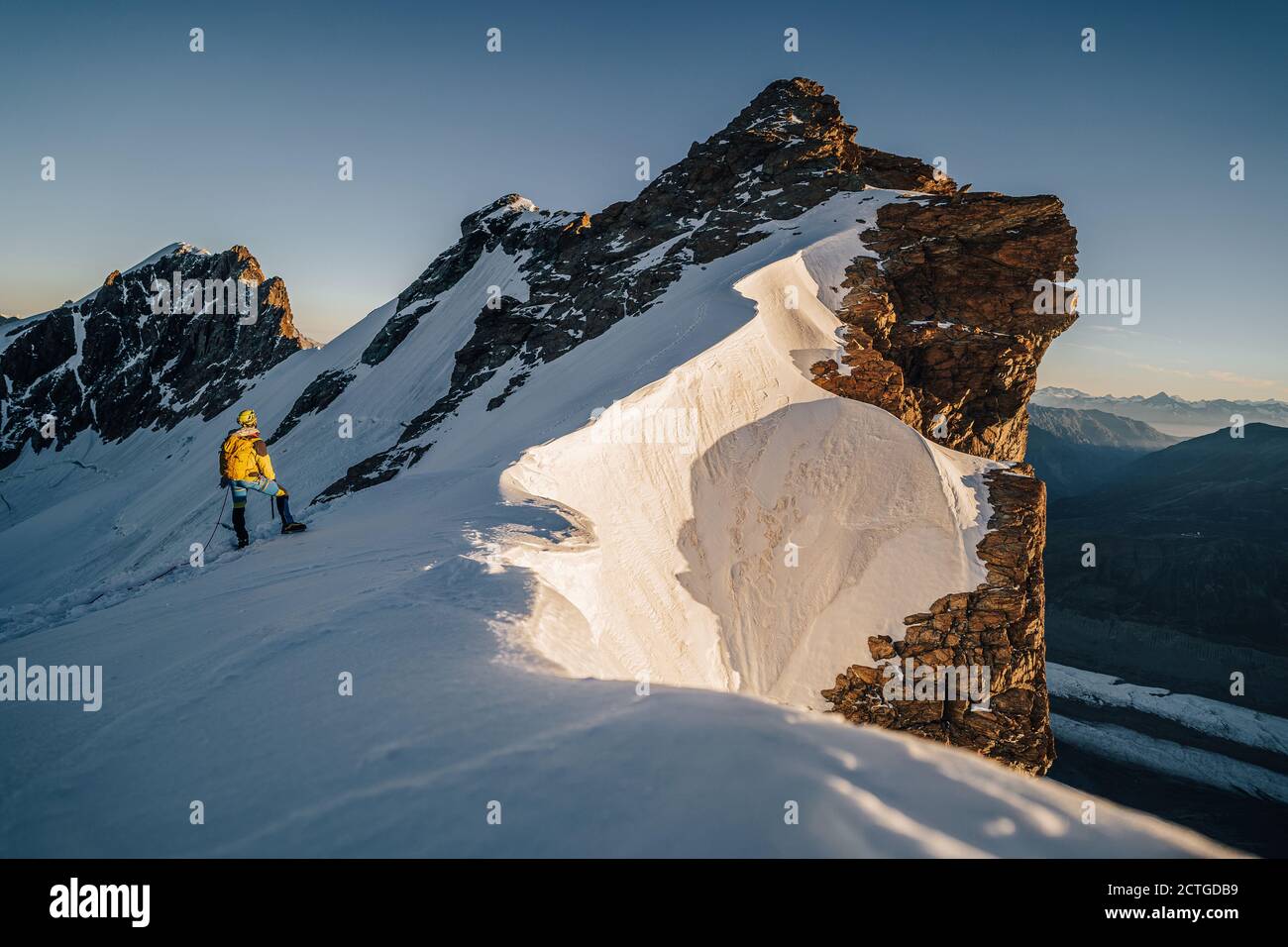 An alpinist climbing alpine peak in Switzerland Stock Photo - Alamy