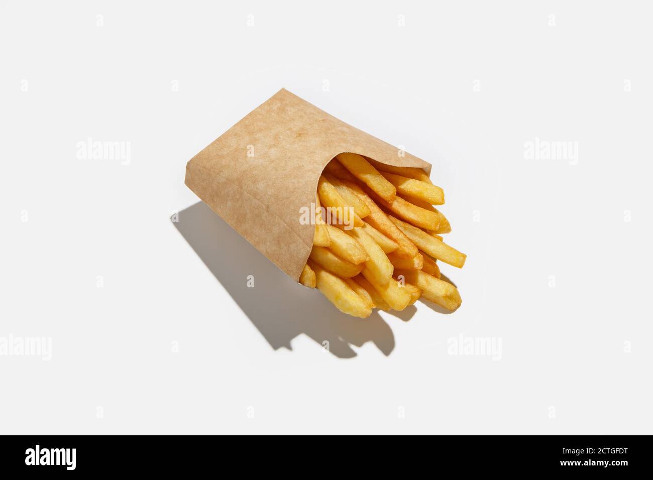 French fries and fast food takeaway in menu during pandemic. Fried potatoes  in ecological paper packaging with shadow Stock Photo - Alamy