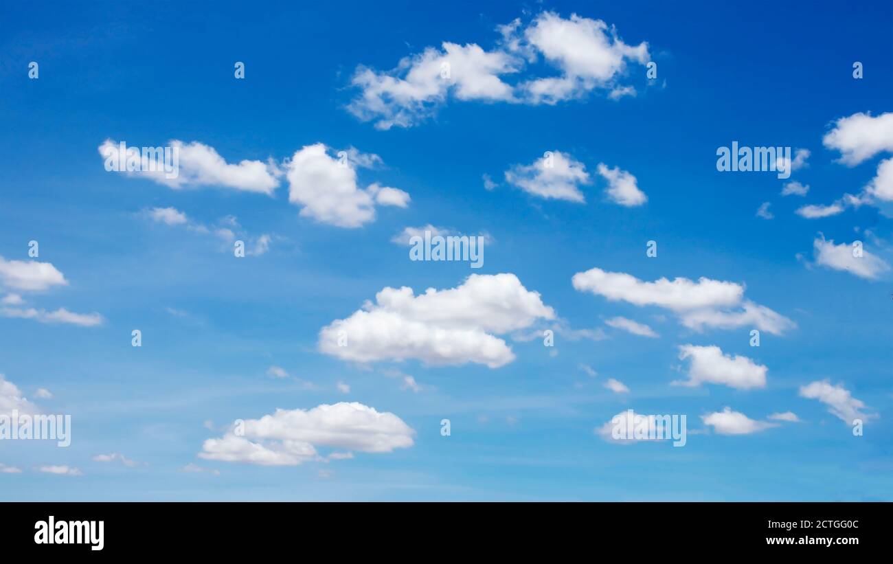 Many blurred white clouds on the beautiful blue sky for use as a background image. Stock Photo