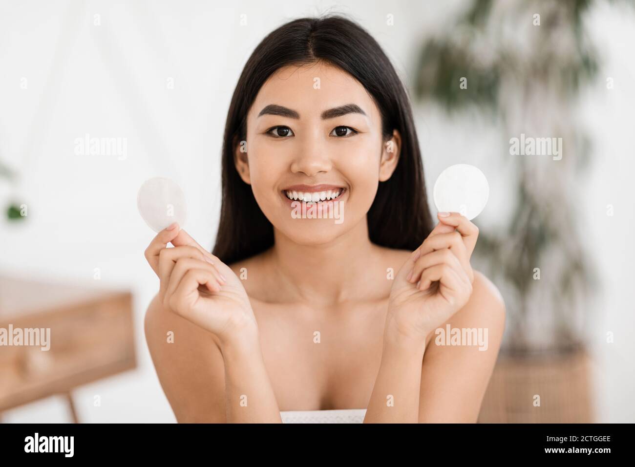 Beautiful asian woman holding two cotton pads Stock Photo