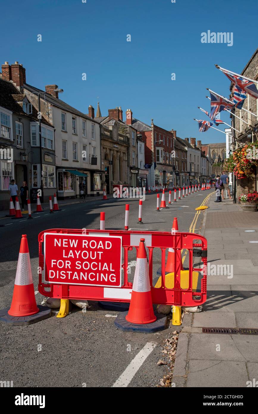 Malmesbury, Wiltshire, England, UK. 2020, Social distancing traffic cones and signage in the main street of this historic market town. Stock Photo