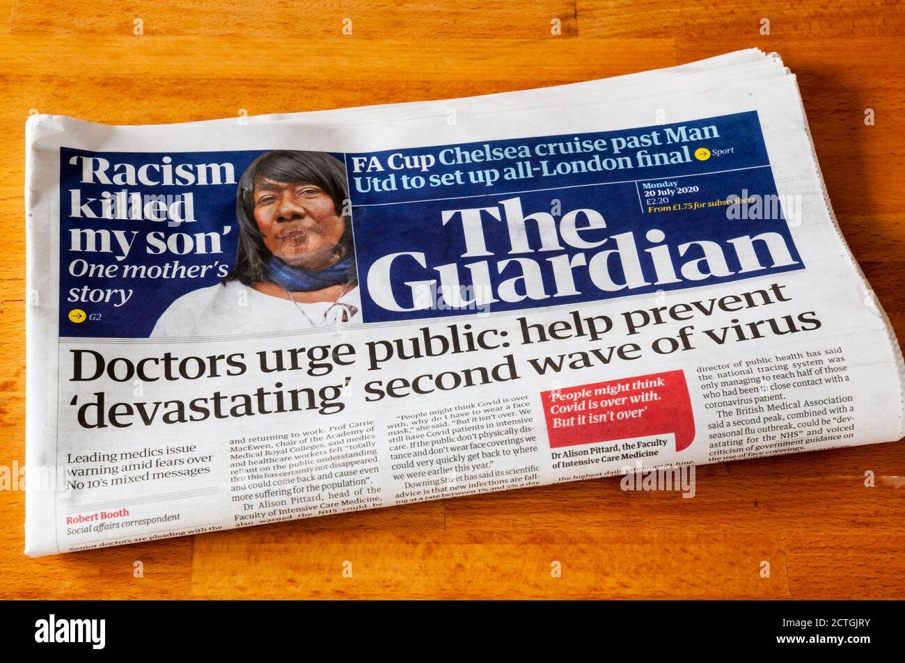 Headline on front page of The Guardian newspaper of 20 July 2020 says doctors urge public to help avoid second wave of coronavirus. Stock Photo