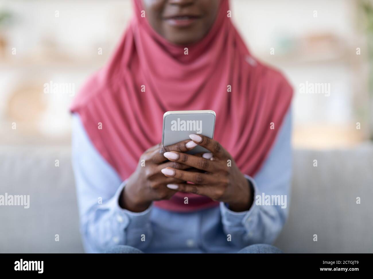 Useful App. Unrecognizable black muslim lady using modern smartphone at ...