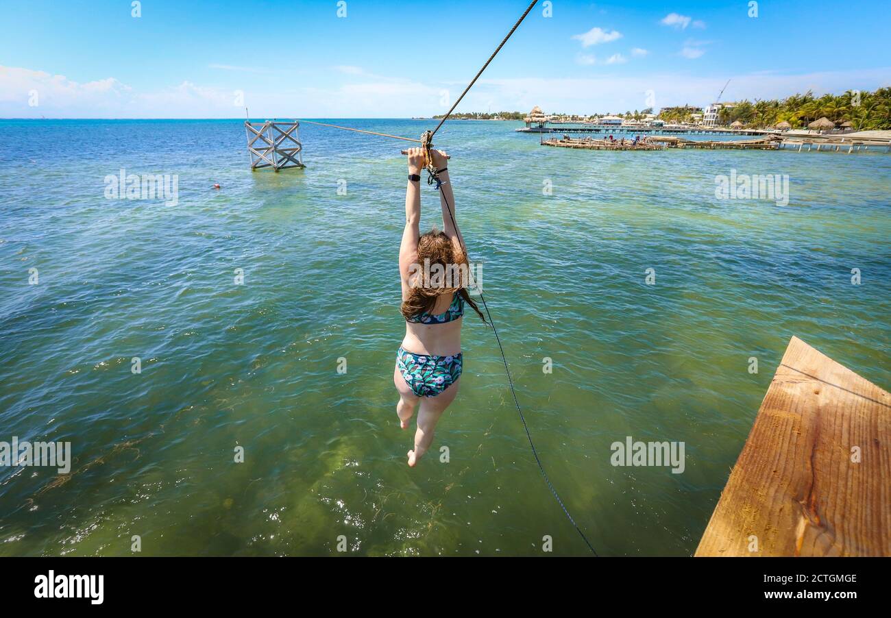 SAN PEDRO, BELIZE Apr 16, 2019 A female tourist rides a zip line at