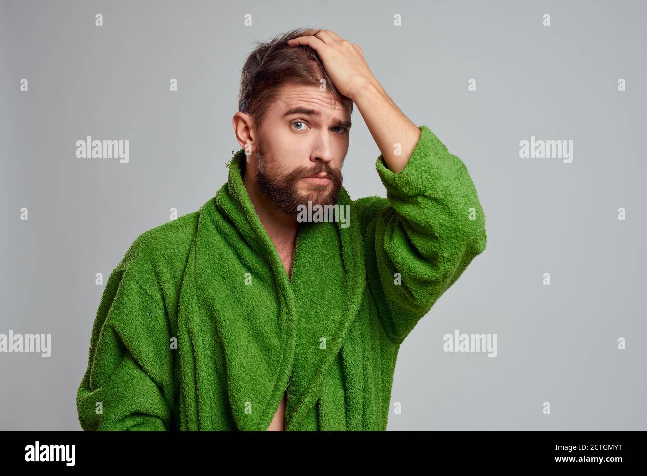 Bearded man in green robe cropped view gray background close-up Stock ...