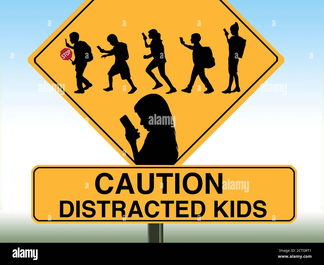 A school crossing sign includes silhouettes of children using cell phones. Stock Photo