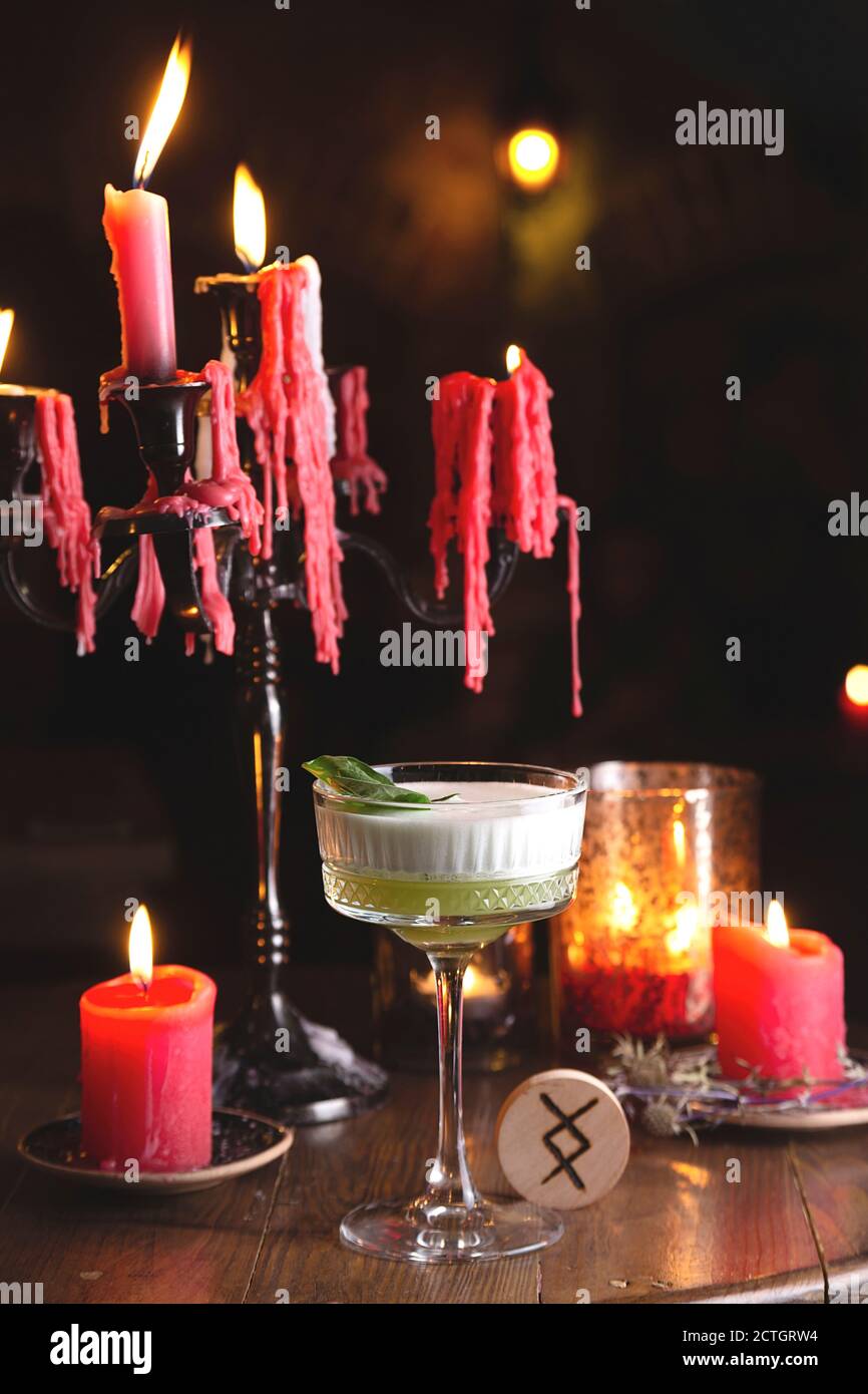 Fresh basil sour cocktail among red lights in dark style Stock Photo