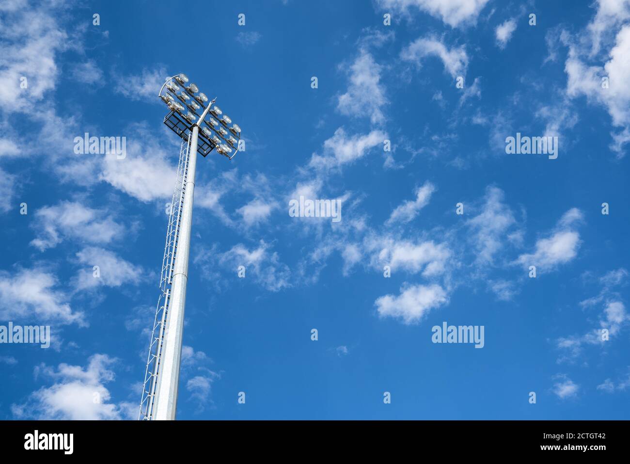 Close up vief of a floodlight in a professional sportsfield. with daylight cloudy blue sky. . High quality photo Stock Photo