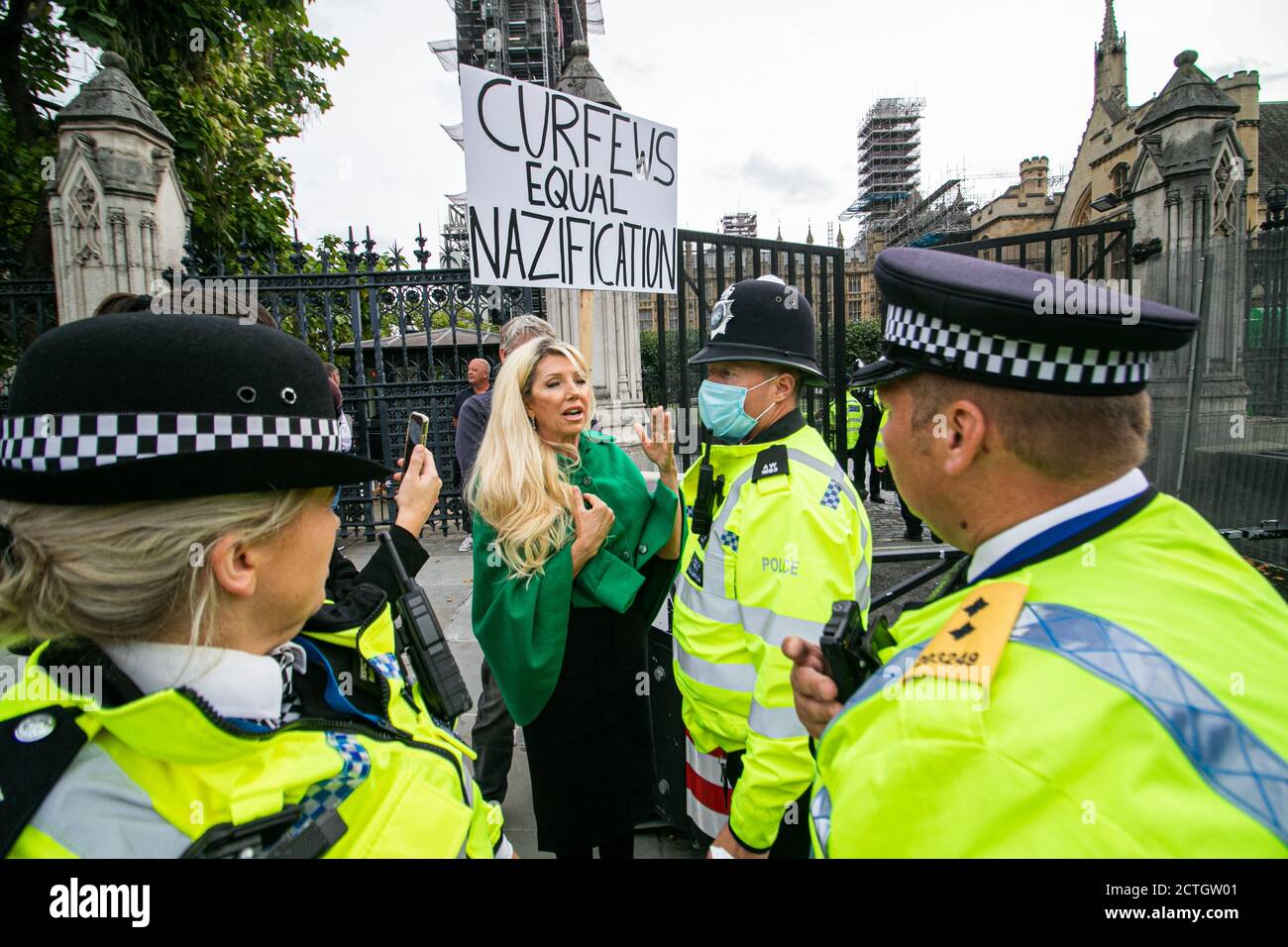 WESTMINSTER LONDON,UK 23 September 2020.  Anti- Vaxxer, Kate Shemirani protests outside Parliament after  Prime Minister Boris imposed new rules and curfews with  coronavirus restrictions on social interactions.  Kate Shemirani  believes there is no pandemic and Covid-19 is a hoax and a government conspiracy to control the masses and Covid vaccination is a political tool to change people's DNA. Credit: amer ghazzal/Alamy Live News Stock Photo
