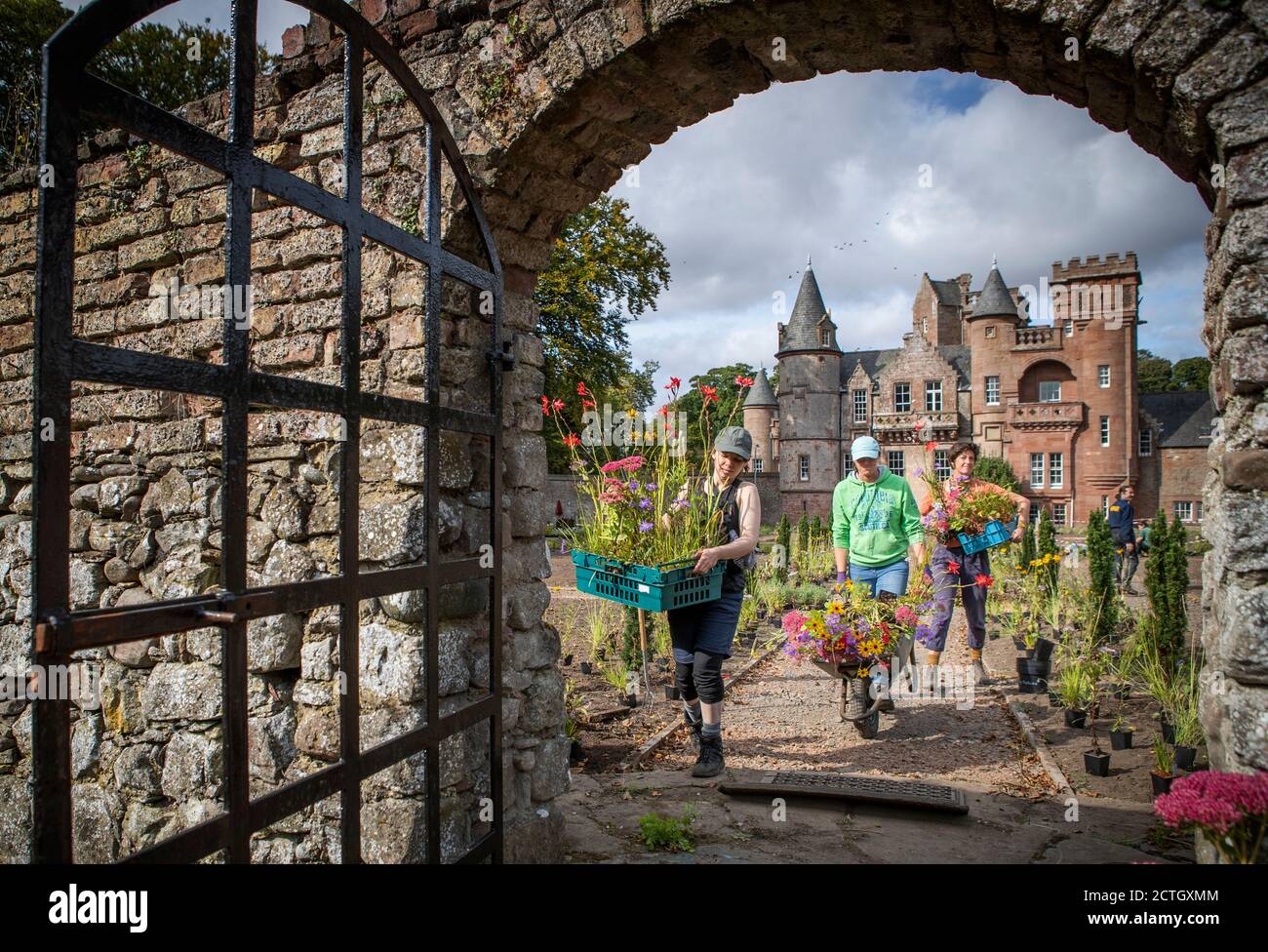 Volunteers (left to right) Kim Moore, Afton Esplin and Jane Porter help with planting for the new garden created by horticulturist and designer Nigel Dunnett in response to the 800 year garden history of the site at Hospitalfield in Arbroath. Stock Photo