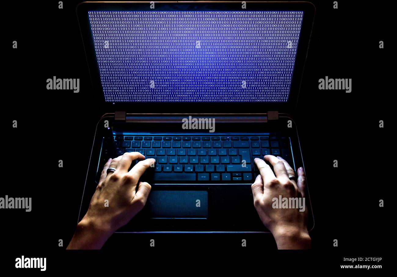 Hacker on the laptop at work Stock Photo