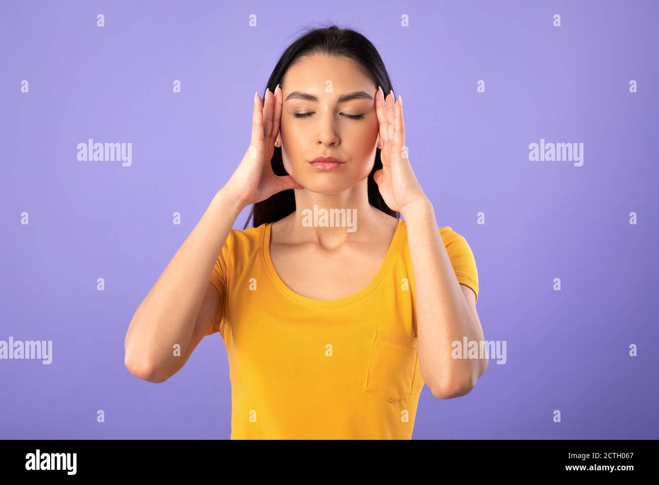 Young woman fingers on temples hi-res stock photography and images - Alamy