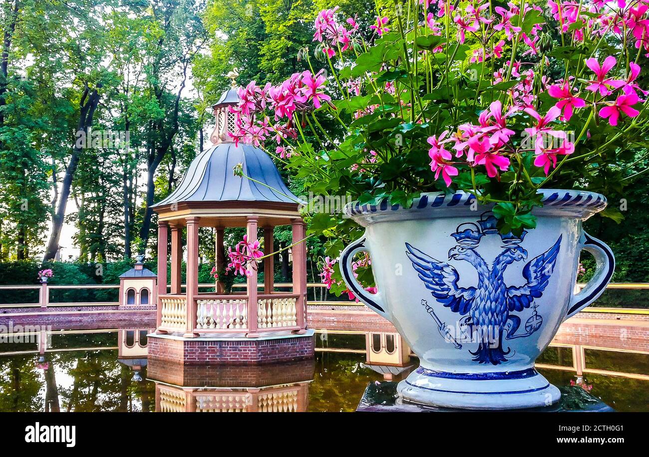 Wooden gazebo and a vase with flowers decorated with double-headed ...