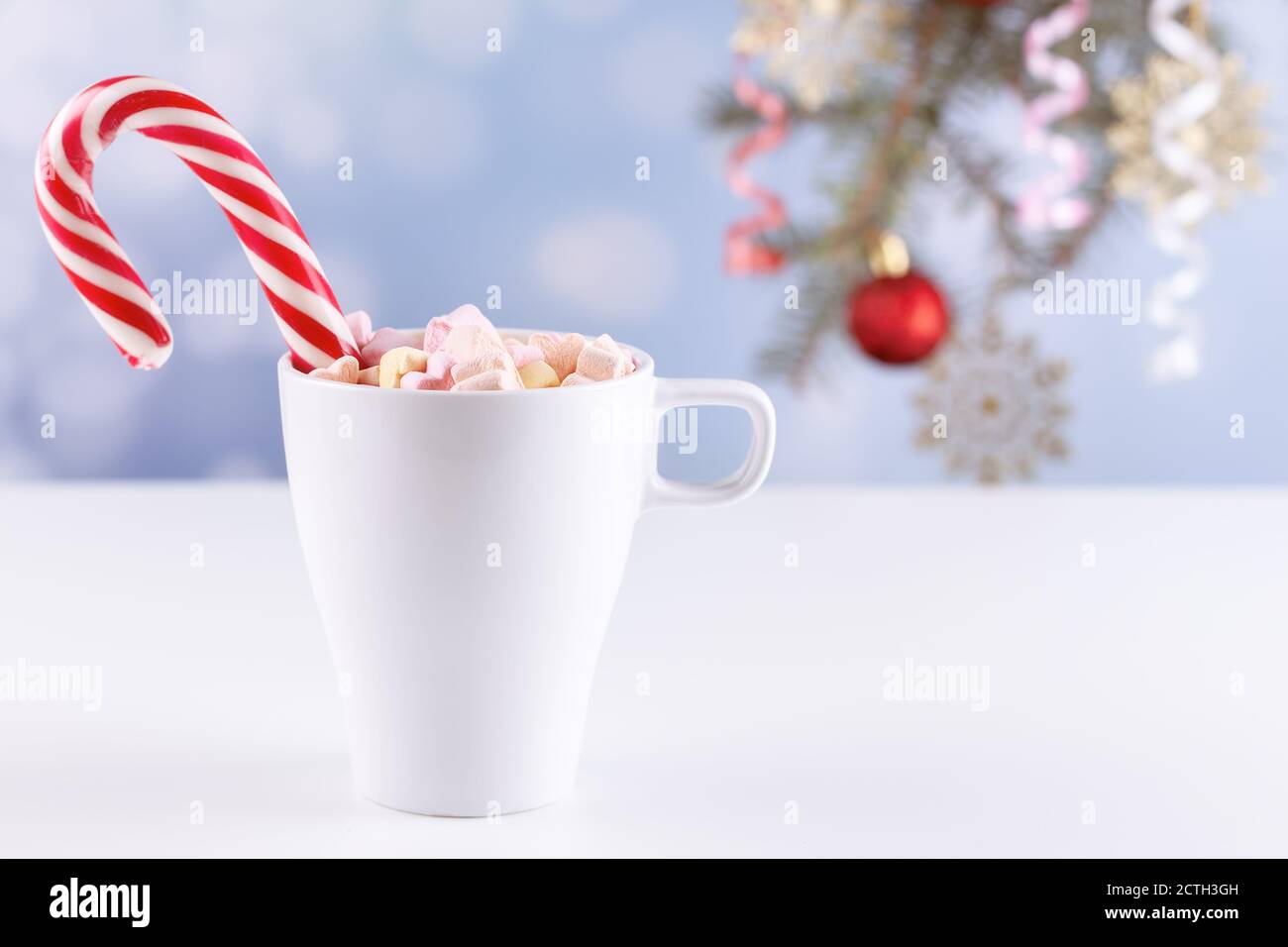 marshmallows and a cup of latte on a white table Stock Photo