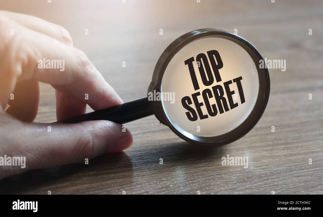 magnifying glass on the top secret text. Business and education concept