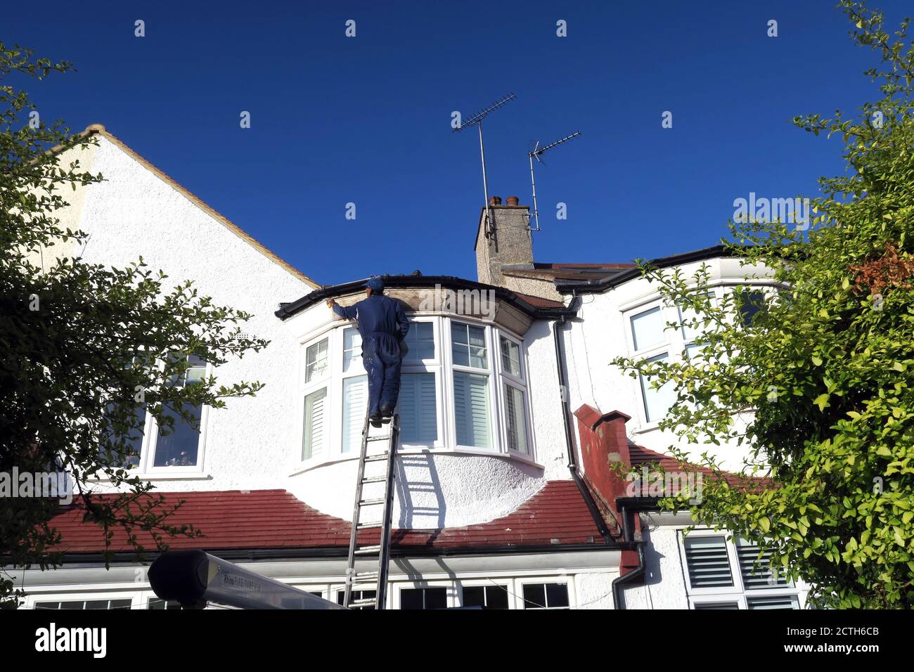 Barnet suburban house with repairman Stock Photo