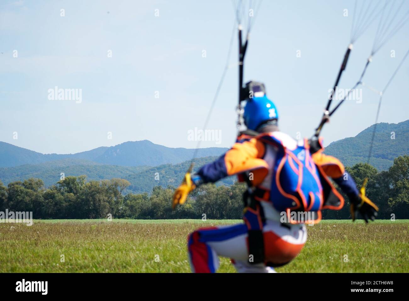 Single parachutist jumped from an air-plane uses a parachute to land. Simple concept with copy space photograph. Stock Photo