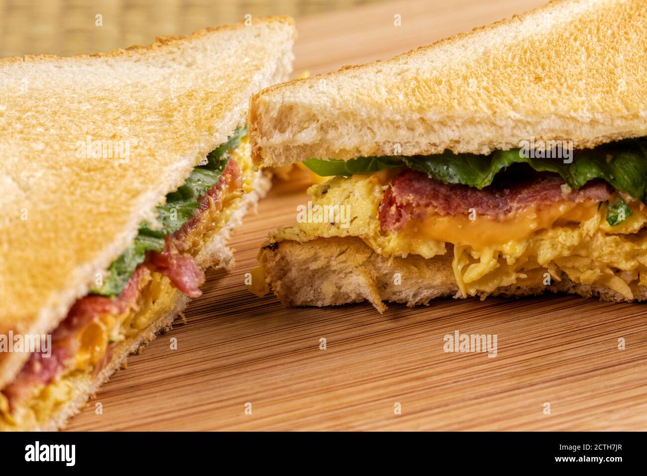 A delicious breakfast sandwich of scrambled eggs and toast with bacon
