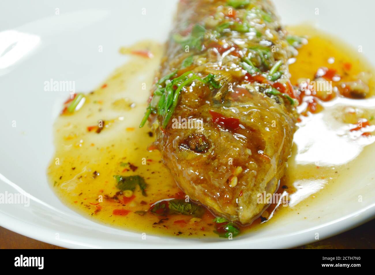 crispy fried sharp tooth snapper dressing with sweet chili sauce on plate Stock Photo