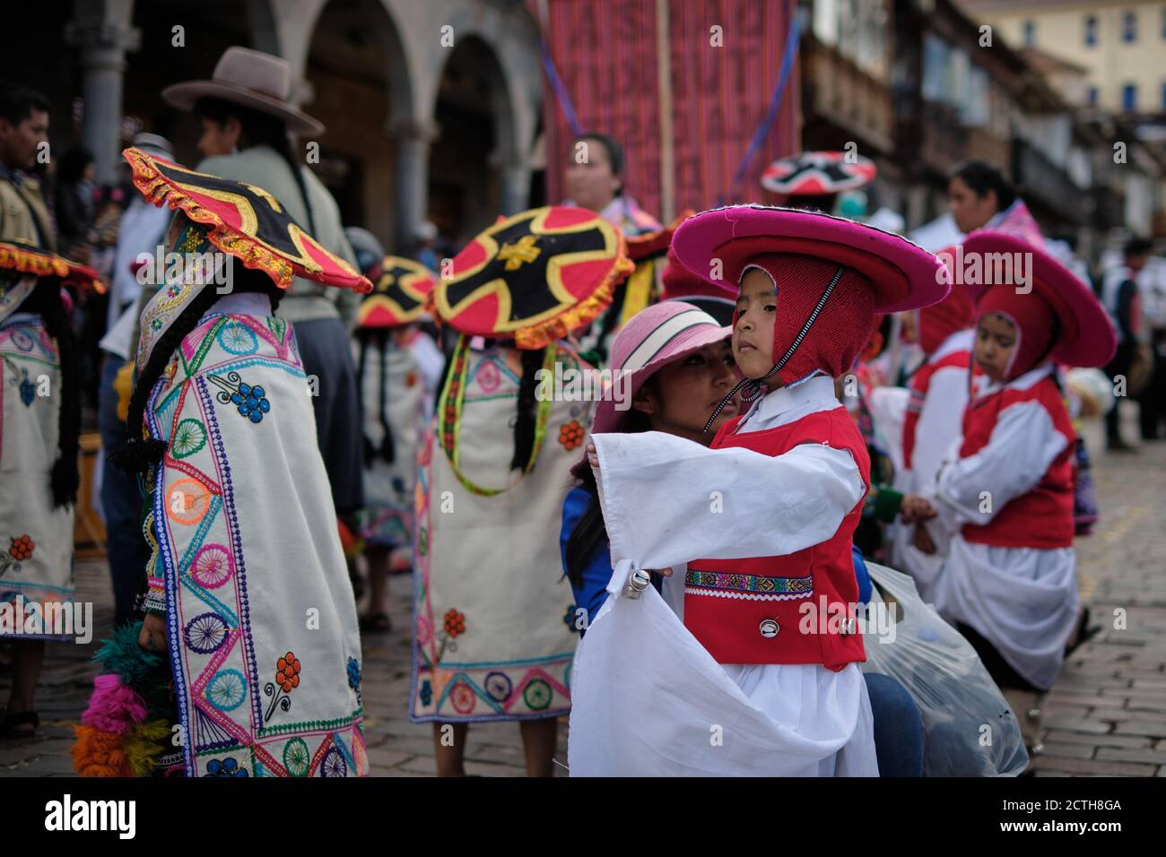 Children in red and white costumes practising dancing for the Inti Raymi'rata sun festival over the winter solstice, Cusco, Peru Stock Photo