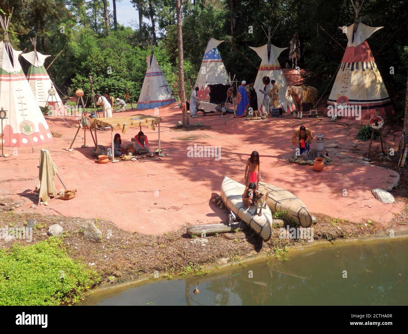 A Native American village display on the banks of a river at Walt Disney World, Orlando Florida, United States Stock Photo